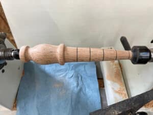 shaped garden dibber on lathe with markings